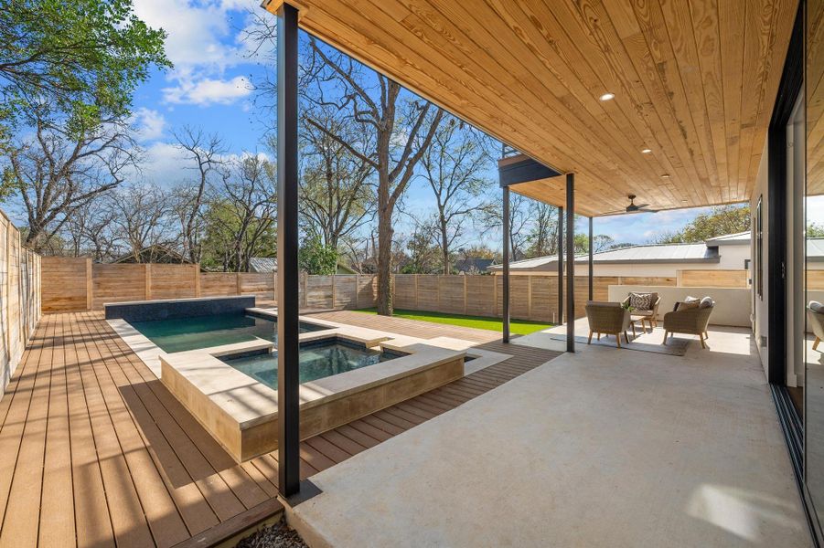 View of swimming pool featuring an in ground hot tub, a fenced backyard, a fenced in pool, and a patio