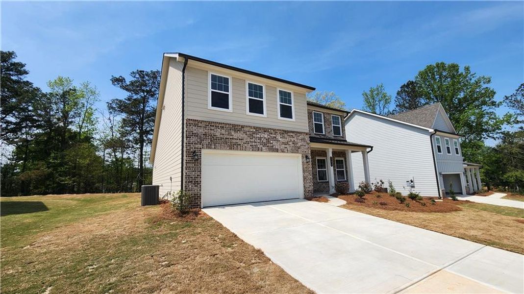 Front exterior of a new home in The Estates at Casteel, Bethlehem, GA, highlighting curb appeal (Image 2). Front exterior of a new home in The Estates at Casteel, Bethlehem, GA, highlighting curb appeal (Image 2).