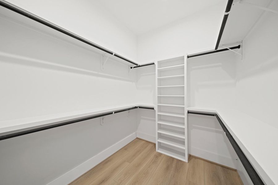 Need closet space? The spacious primary closet has recessed lights, luxury vinyl plank flooring and includes double-hung wardrobe storage rods and plenty of shelf storage. Need closet space? The spacious primary closet has recessed lights, luxury vinyl plank flooring and includes double-hung wardrobe storage rods and plenty of shelf storage.