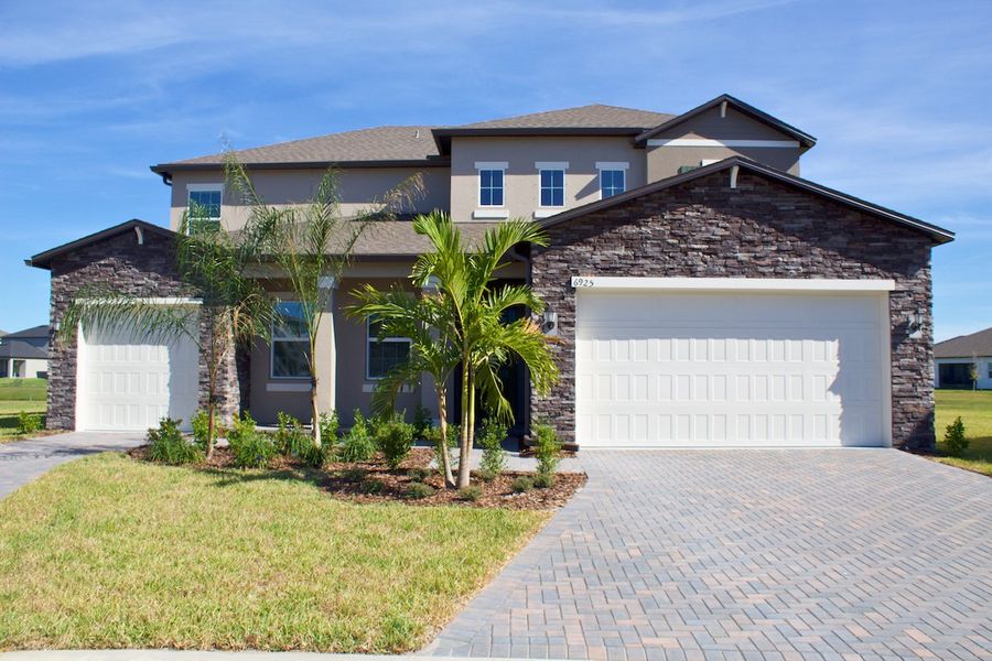 Front exterior of a new home in Stonegate Preserve: The Executives, Palmetto, FL, highlighting curb appeal (Image 1).