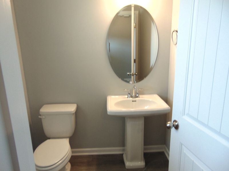 This powder room for all your guests, comes with a updated modern sink, and an elongated toilet for comfort. This powder room for all your guests, comes with a updated modern sink, and an elongated toilet for comfort.