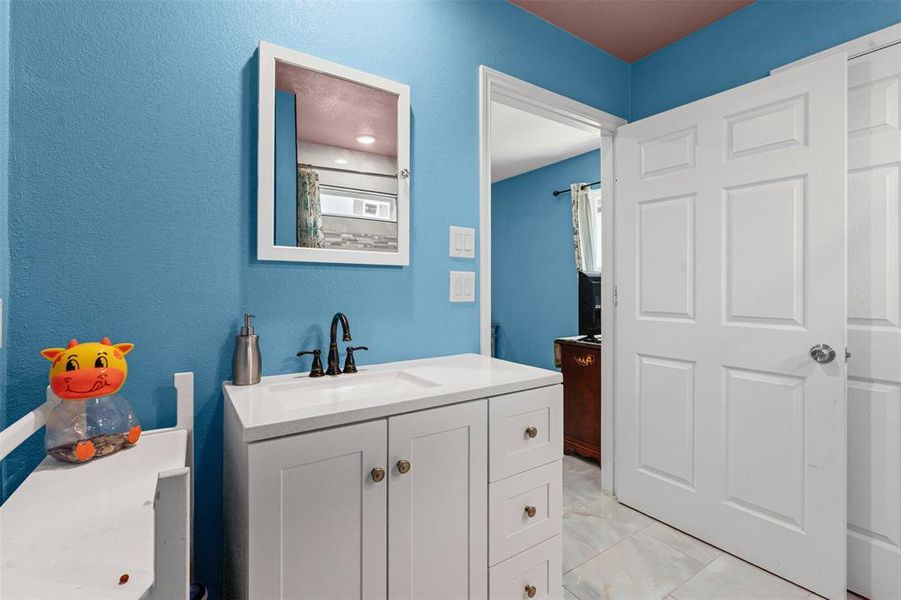 Full bathroom with a shower with curtain and vanity Full bathroom with a shower with curtain and vanity