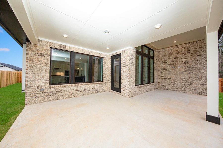 Step outside to the covered rear patio, the perfect extension of your indoor living space for year-round enjoyment.