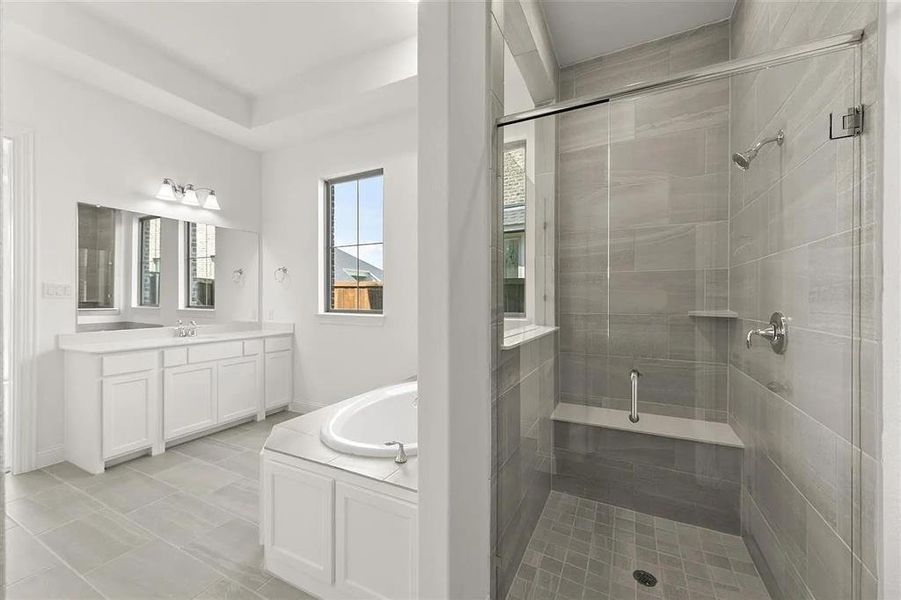 Bathroom with plus walk in shower, vanity, and tile patterned flooring