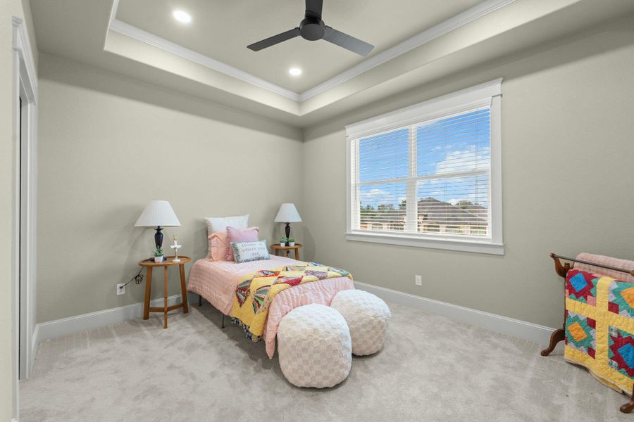 Carpeted room featuring a tray ceiling with recessed lighting and a ceiling fan
