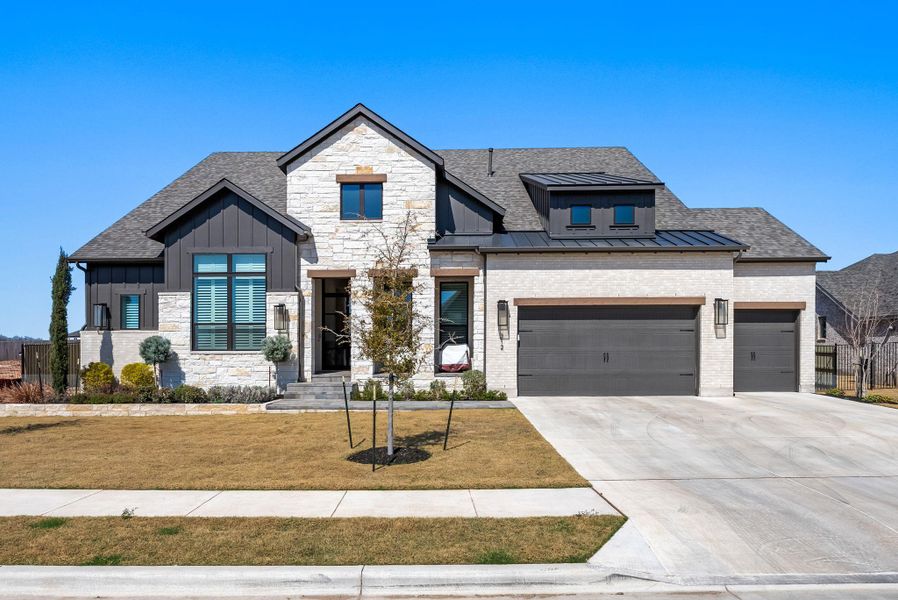 Front exterior of a new home in Santa Rita Ranch, Liberty Hill, TX, highlighting curb appeal (Image 2). Front exterior of a new home in Santa Rita Ranch, Liberty Hill, TX, highlighting curb appeal (Image 2).