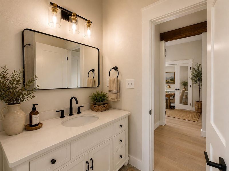 An elegant vanity coordinates beautifully with the nearby hallway flooring and trim work.Virtual Staging. An elegant vanity coordinates beautifully with the nearby hallway flooring and trim work.Virtual Staging.