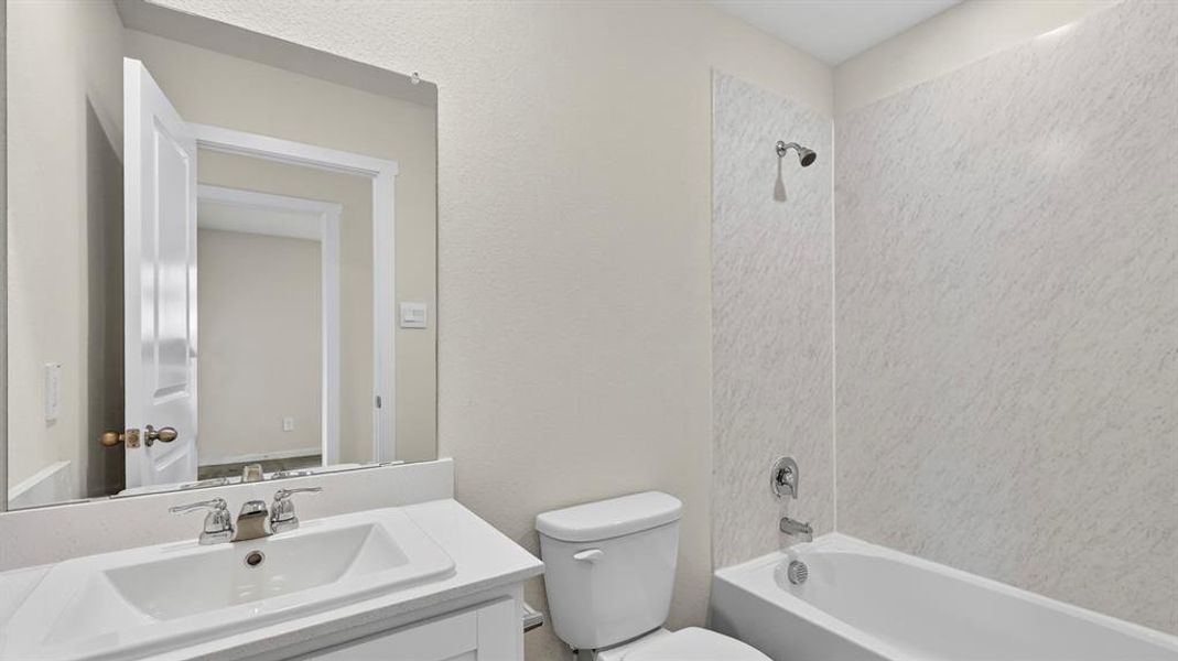 Bathroom featuring a vanity with a white countertop, an integrated sink, and a chrome faucet