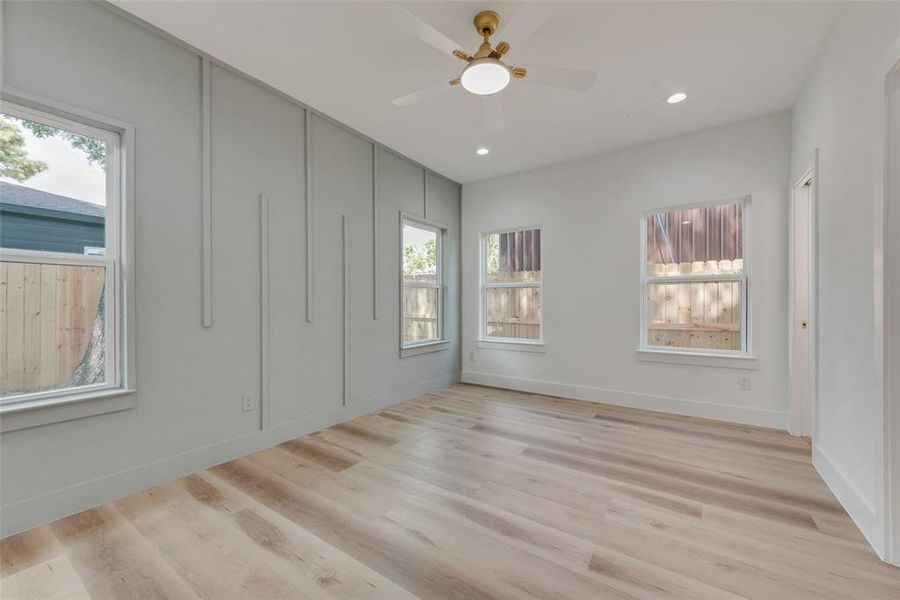 Unfurnished room with ceiling fan and light wood-type flooring