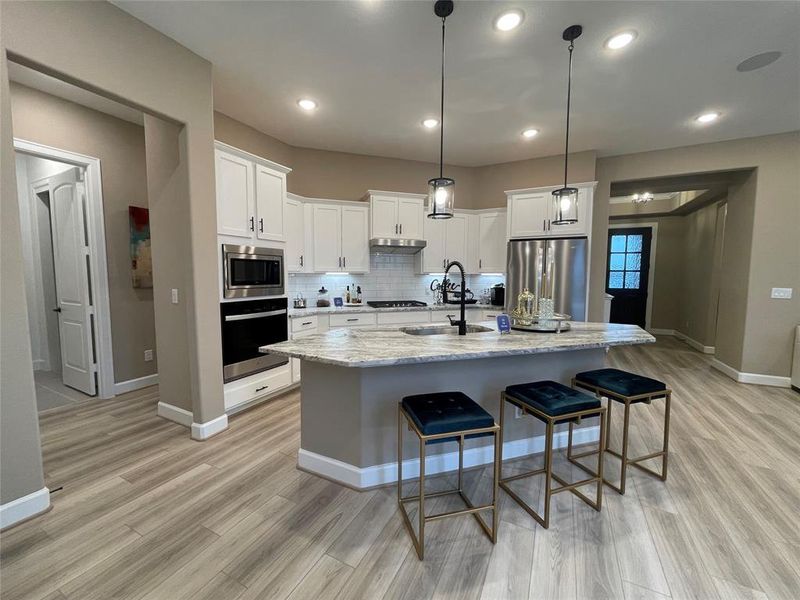 Experience Culinary excellence in the kitchen where state-of-the-art appliances meet sophisticated design.  This gormet space boasts expansive countertops, stylish cabinetry, and top of the line fixtures creating an ideal environment for both casual meals and lavish entertaining.