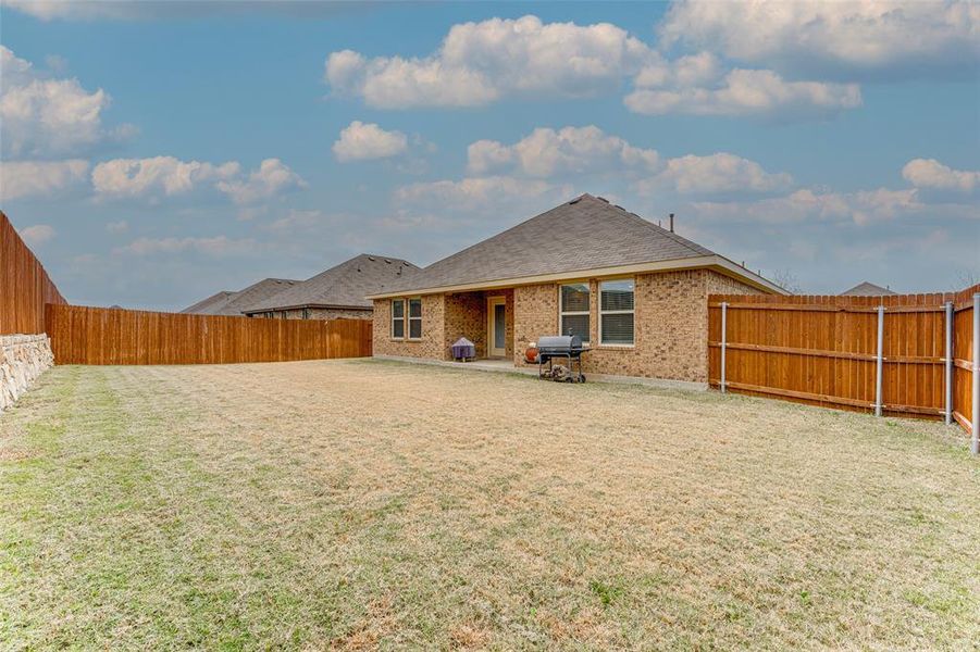 Back of house with a lawn