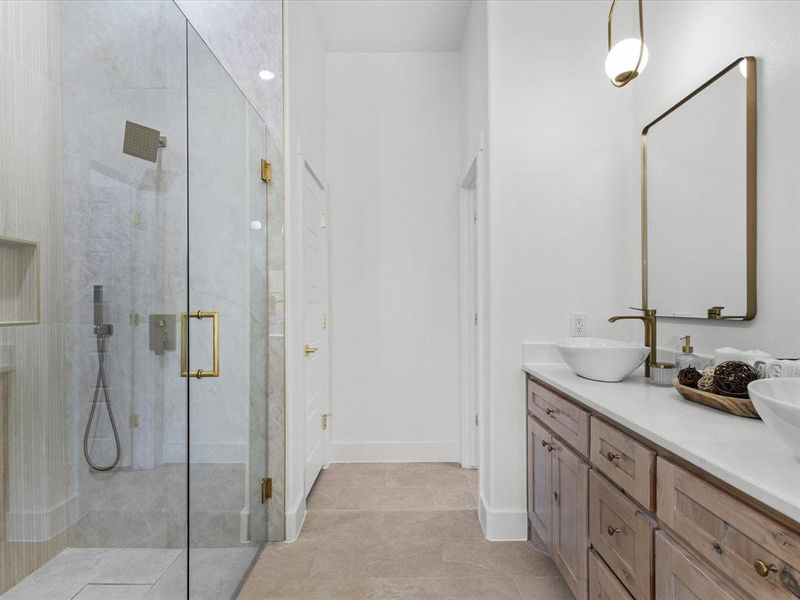 Full bathroom with double vanity, a stall shower, and light tile patterned flooring