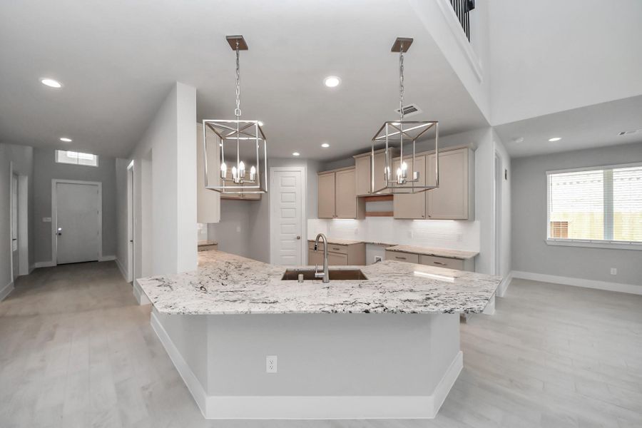 This kitchen is truly a chef's dream! This haven Boasts high ceilings, recessed & pendant lighting, stained wood cabinets, granite countertops, stainless steel appliances, a modern tile backsplash. All of this overlooks your expansive family room, creating a perfect space for culinary delights and family gatherings. This kitchen is truly a chef's dream! This haven Boasts high ceilings, recessed & pendant lighting, stained wood cabinets, granite countertops, stainless steel appliances, a modern tile backsplash. All of this overlooks your expansive family room, creating a perfect space for culinary delights and family gatherings.