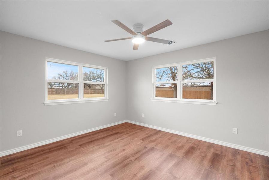 Spare room featuring ceiling fan and light wood-type flooring Spare room featuring ceiling fan and light wood-type flooring