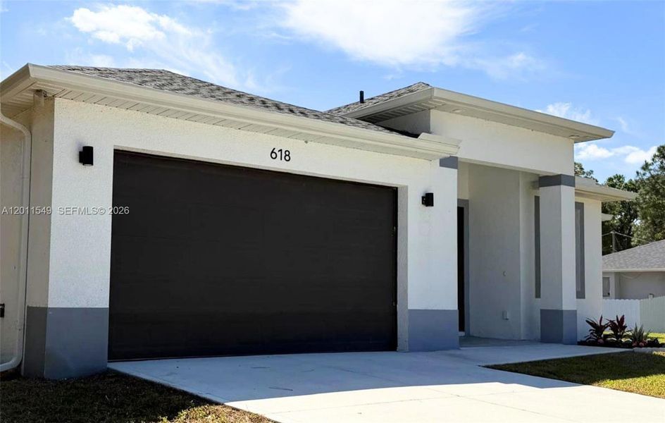 Front exterior of a new home in , Lehigh Acres, FL, highlighting curb appeal (Image 23). Front exterior of a new home in , Lehigh Acres, FL, highlighting curb appeal (Image 23).