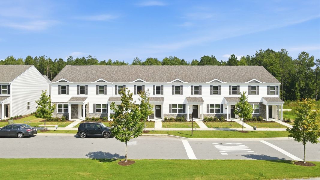 Front exterior of a new home in Clock Road Townhomes, New Bern, NC, highlighting curb appeal (Image 20). Front exterior of a new home in Clock Road Townhomes, New Bern, NC, highlighting curb appeal (Image 20).