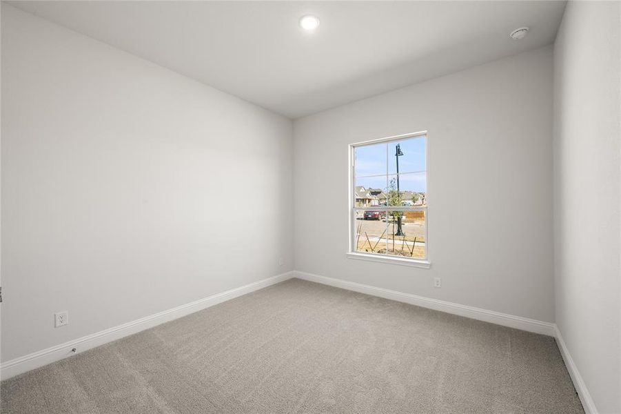 Secondary bedroom featuring carpet floors