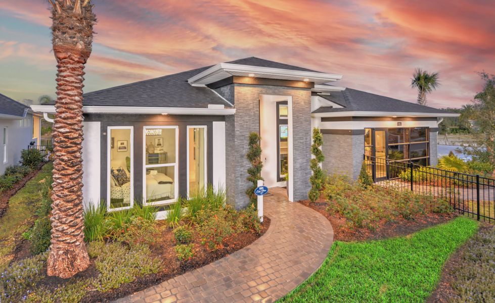 Front exterior of a new home in Mosaic, Daytona Beach, FL, highlighting curb appeal (Image 1).