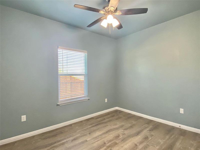 Well-lit sleeping quarters with a ceiling fan, ready for your personal touch. Well-lit sleeping quarters with a ceiling fan, ready for your personal touch.