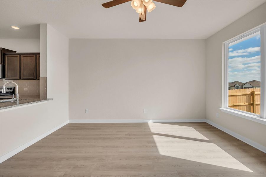 Unfurnished room with light wood-type flooring and a ceiling fan