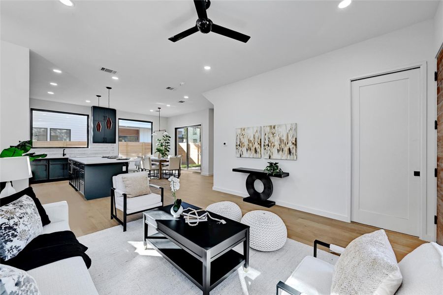 Living area with recessed lighting, light wood-style floors, and a ceiling fan