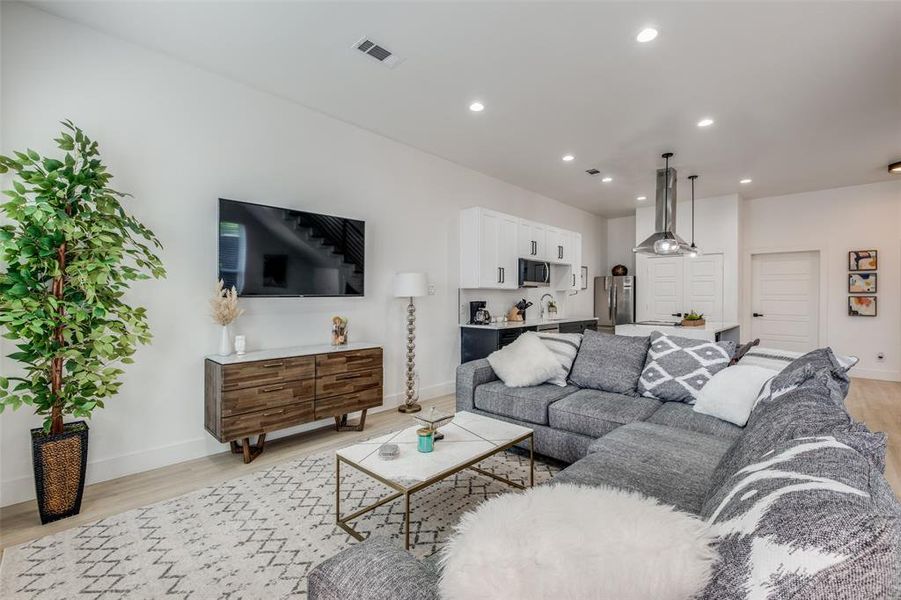 Living room with light hardwood / wood-style floors