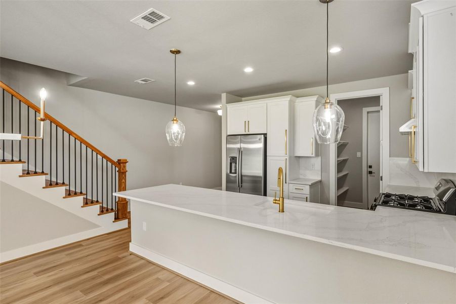 Discover a sleek bar area perfect for entertaining, with ample space for barstools and stylish lighting to set the mood.