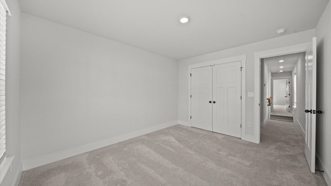 First-rate bedroom with plush carpeting and large windows that provide an open, airy feel