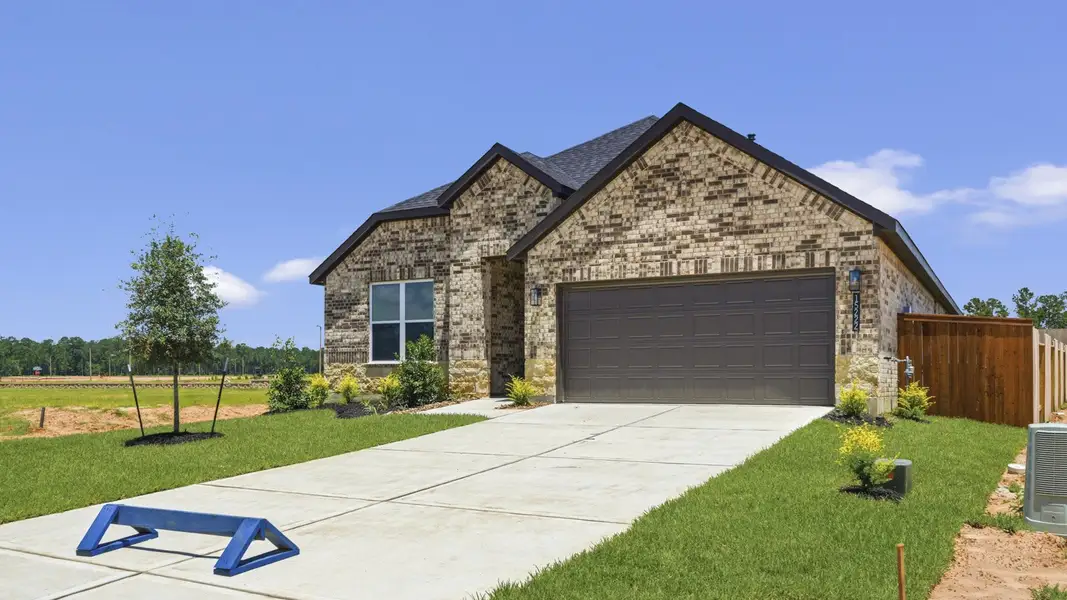 Front exterior of a new home in Mill Creek Estates, Magnolia, TX, highlighting curb appeal (Image 2). Front exterior of a new home in Mill Creek Estates, Magnolia, TX, highlighting curb appeal (Image 2).