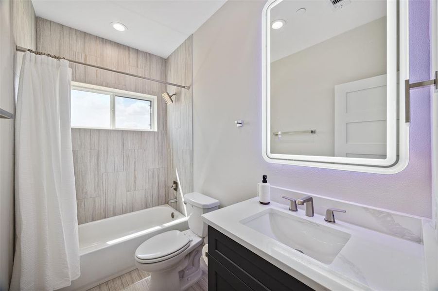 Fourth floor full bathroom features a large vanity and tub/shower combo.