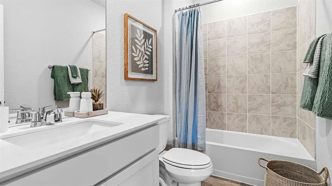 Bathroom featuring a white vanity with an integrated sink, polished chrome faucet, and a large wall-mounted mirror