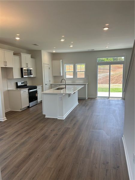 A contemporary kitchen space boasts gleaming hardw
