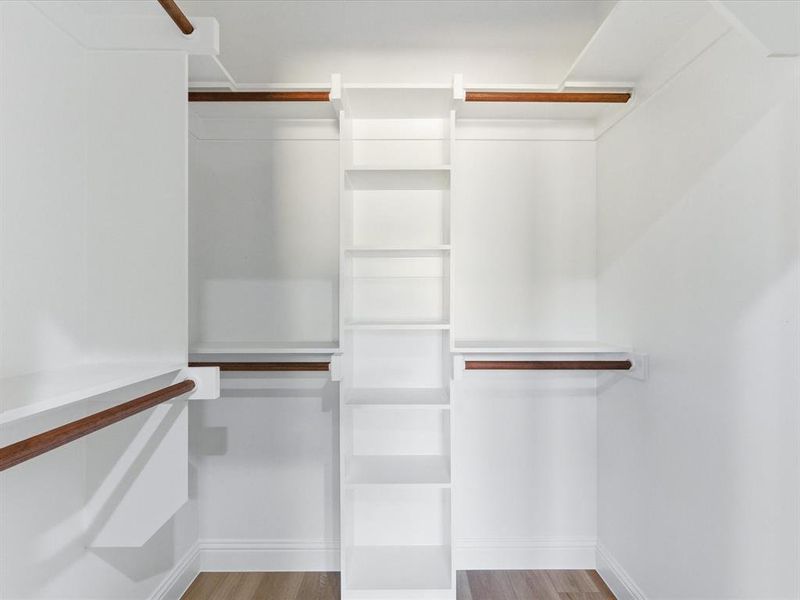 Spacious closet featuring light wood finished floors Spacious closet featuring light wood finished floors