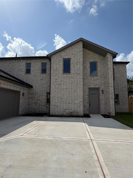 Front exterior of a new home in , Spring, TX, highlighting curb appeal (Image 14).