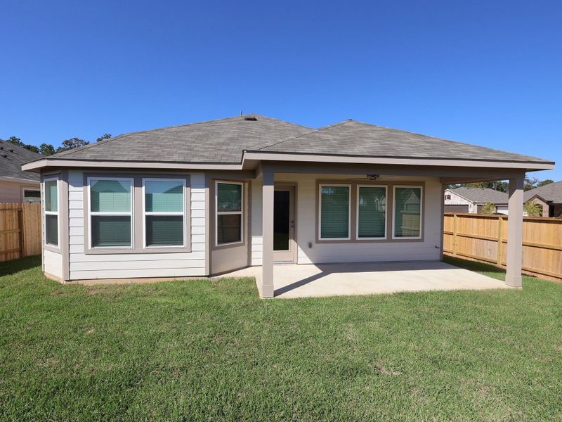 Exterior details and patio area of a home in Pinewood at Grand Texas, New Caney (Image 2). Exterior details and patio area of a home in Pinewood at Grand Texas, New Caney (Image 2).