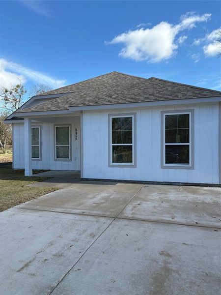 View of front of home featuring a shingled roof