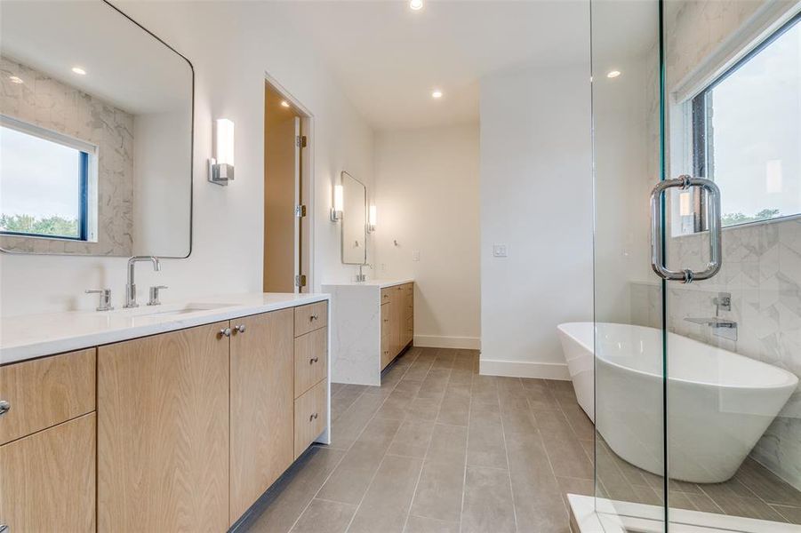 Beauty abounds with waterfall quartz counters, sleek cabinetry and natural light