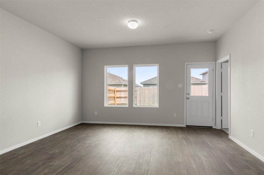 Empty room featuring dark wood-style flooring and baseboards Empty room featuring dark wood-style flooring and baseboards