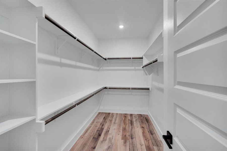 Primary closet with plenty of hanging and shelf space.