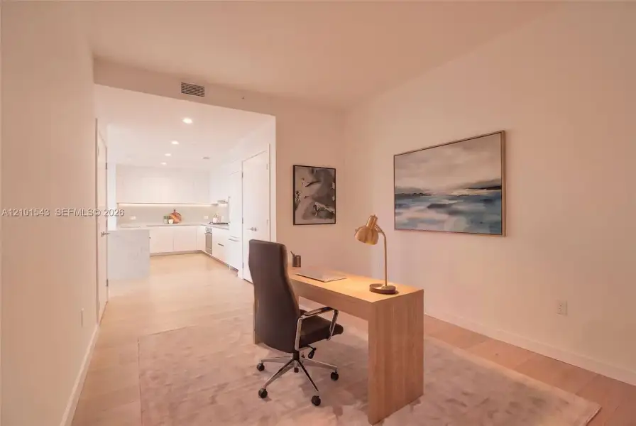 Light-toned wood-finish flooring, white flat-panel cabinetry, quartz countertops, and recessed ceiling lighting