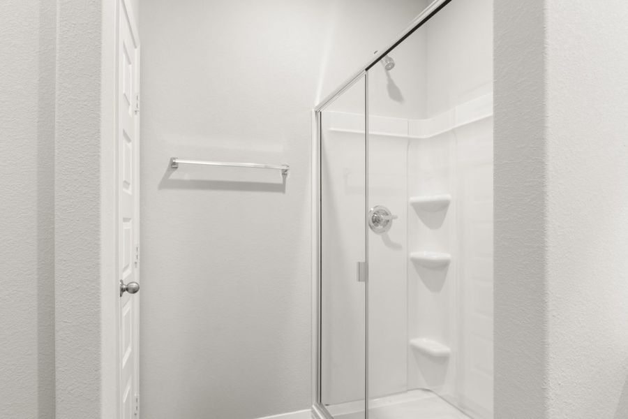 Image of a primary bathroom standing shower with white vinyl Image of a primary bathroom standing shower with white vinyl