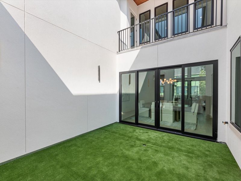 A fully turfed private courtyard, just off the dining room with Pella sliding door and foyer, offers a rare retreat in the city- destined to be your favorite gathering space and a true showpiece for entertaining.