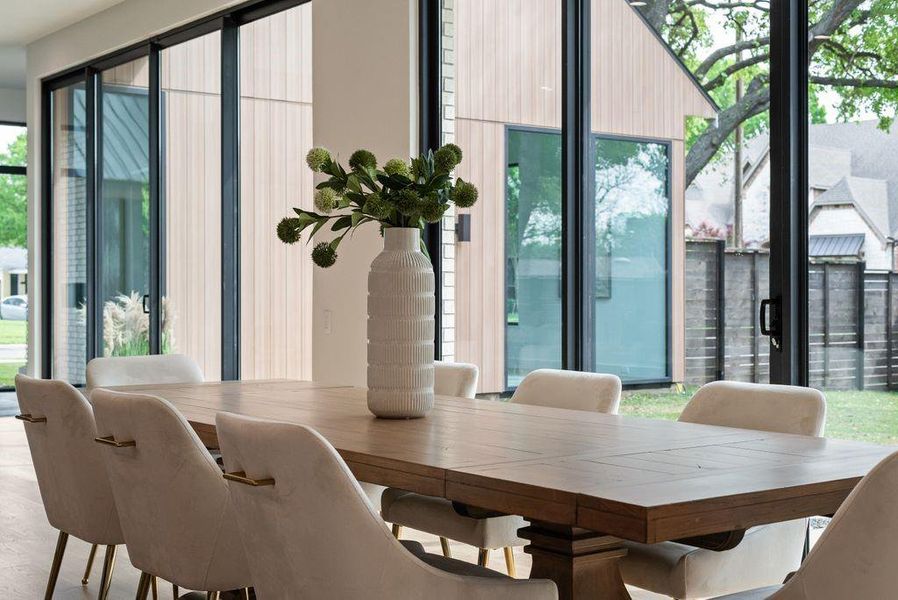 Surrounded by natural light, the dining area offers an inviting setting for both everyday living and entertaining.