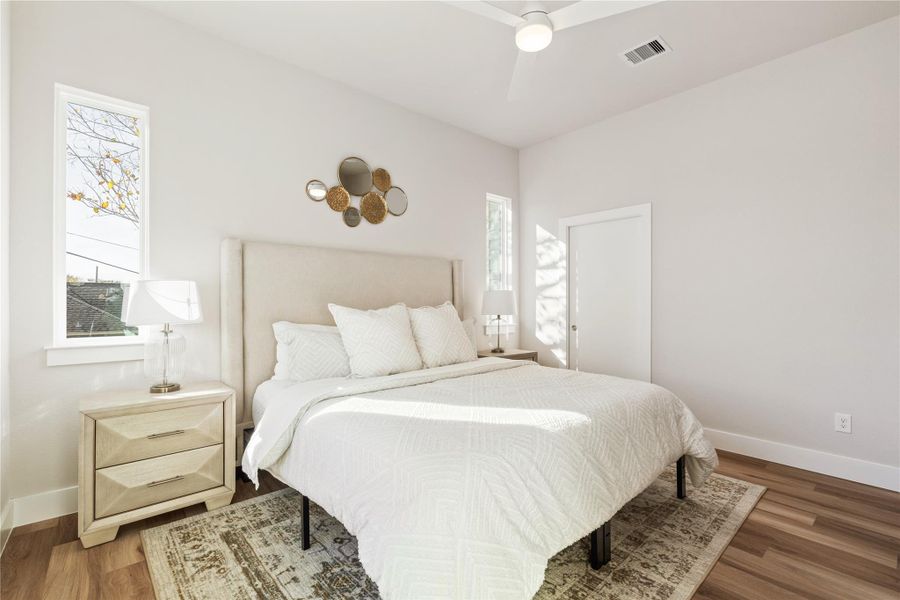 A second view of the primary suite, where clean lines and soft natural light lead directly into the expansive walk-in closet and private ensuite, creating a true sense of separation from the rest of the home.