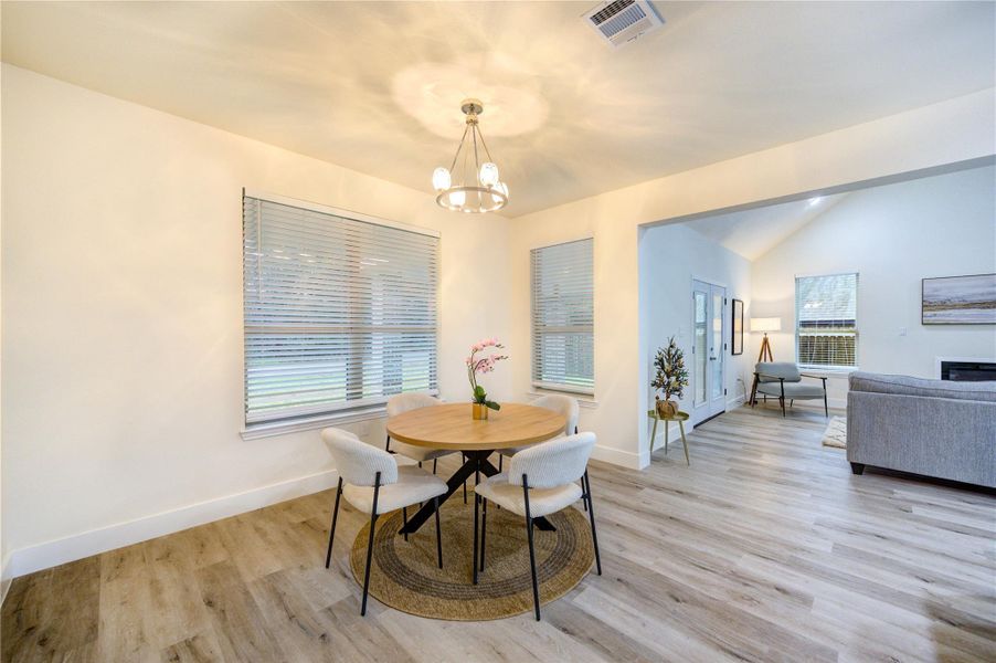 Bright and inviting dining area with modern lighting and plenty of natural light.