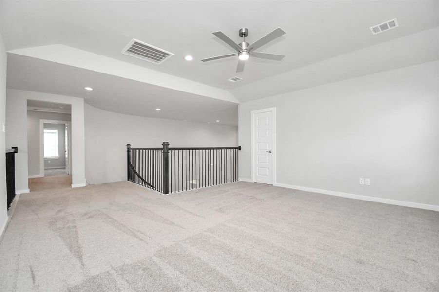 Ascend to relaxation in this fantastic game room! Ideal for both casual gatherings and adult gaming, it boasts plush carpet, lofty ceilings, custom paint, and ample windows for abundant natural light