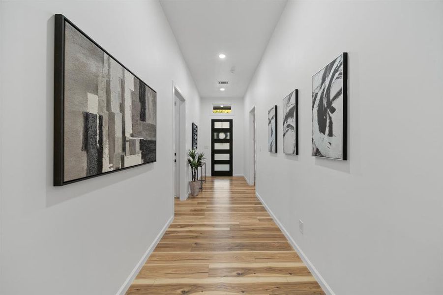 Living room with ceiling fan and hardwood / wood-style floors