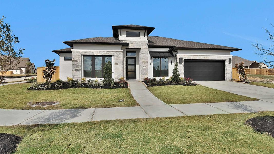 Front exterior of a new home in Valencia 70', Manvel, TX, highlighting curb appeal (Image 1). Front exterior of a new home in Valencia 70', Manvel, TX, highlighting curb appeal (Image 1).