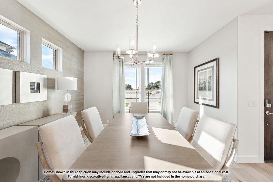 Formal dining room with long wood table, eight chairs, chandelier, and large windows with natural light. Formal dining room with long wood table, eight chairs, chandelier, and large windows with natural light.
