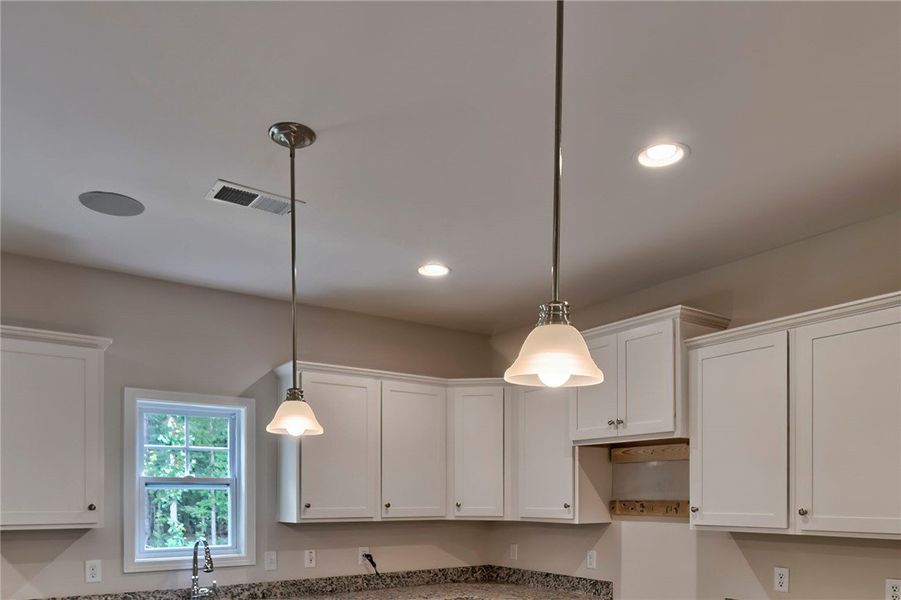 This bright kitchen features ample cabinetry and b